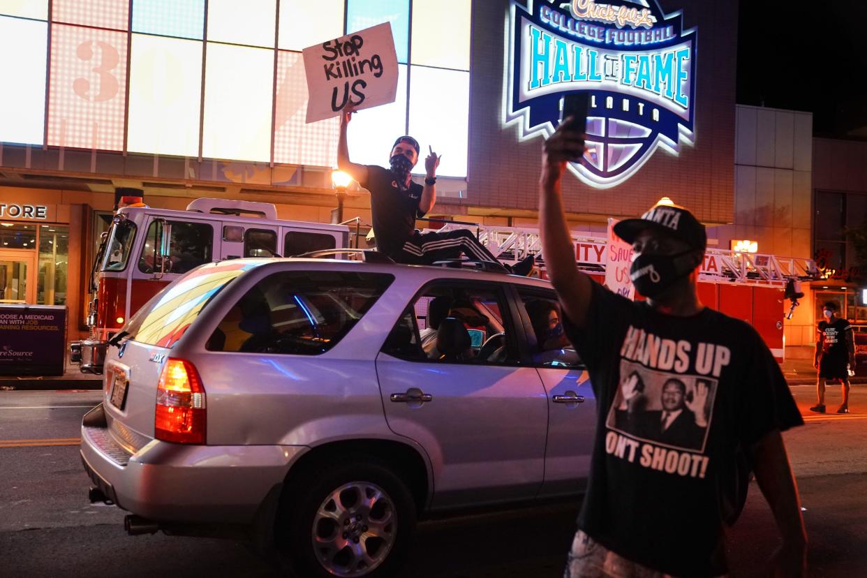 ATLANTA, GA - MAY 29: People hold signs during a protest on May 29, 2020 in Atlanta, Georgia. Demonstrations are being held across the US after George Floyd died in police custody on May 25th in Minneapolis, Minnesota. (Photo by Elijah Nouvelage/Getty Images)