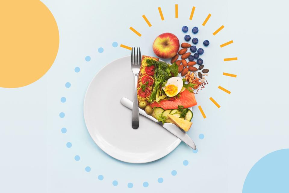 Here's How Intermittent Fasting Might Benefit Your Immune System , A plate seen from above with the knife and fork arranged to resemble the hands of a clock with food arranged to illustrate the concept of intermittent fasting