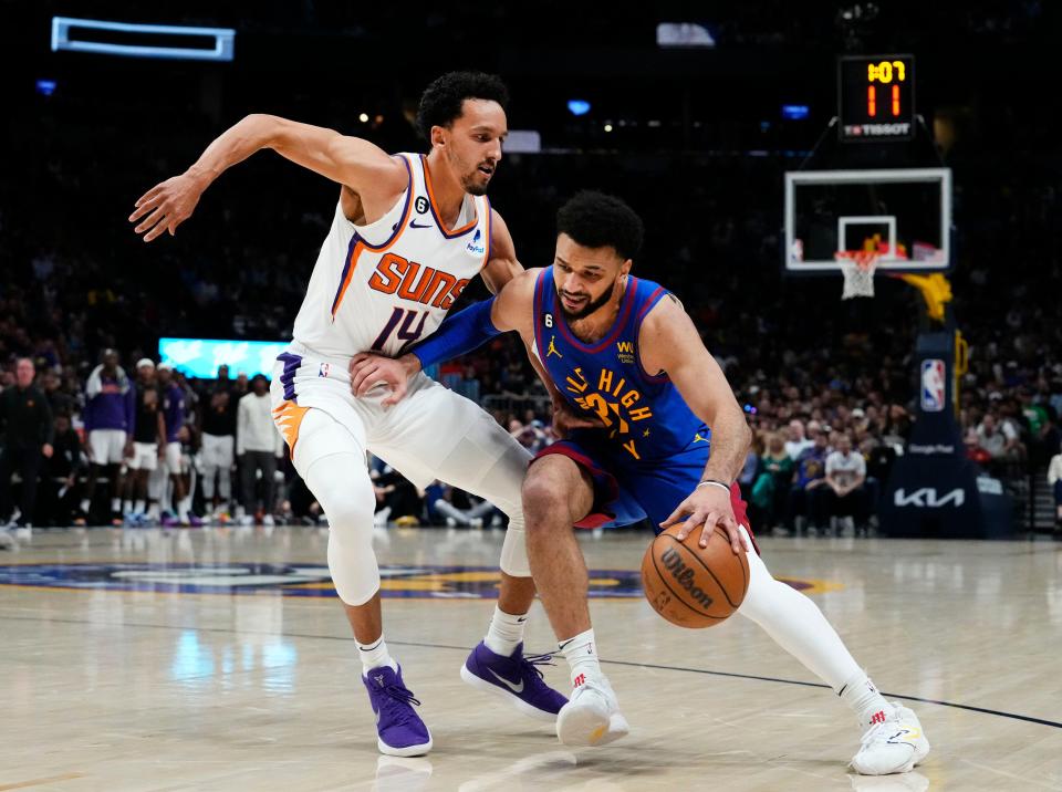 Apr 29, 2023;  Denver, CO, USA;  Denver Nuggets guard Jamal Murray (27) drives the ball against Phoenix Suns guard Landry Shamet (14) in the third quarter during Game 1 of the Western Conference Semifinals at Ball Arena.  Mandatory Credit: Rob Schumacher-Arizona Republic