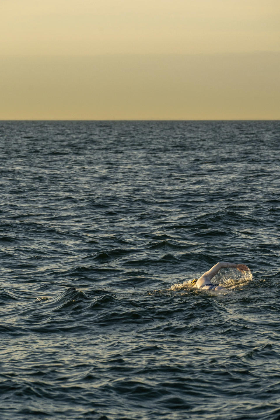 This undated photo shows American swimmer Sarah Thomas, 37, swim the English Channel. The American cancer survivor has become the first person to swim across the English Channel four times in a row completing the remarkable feat Tuesday morning Sept. 17, 2019, after more than 54 hours of swimming. (Jon Washer via PA via AP)