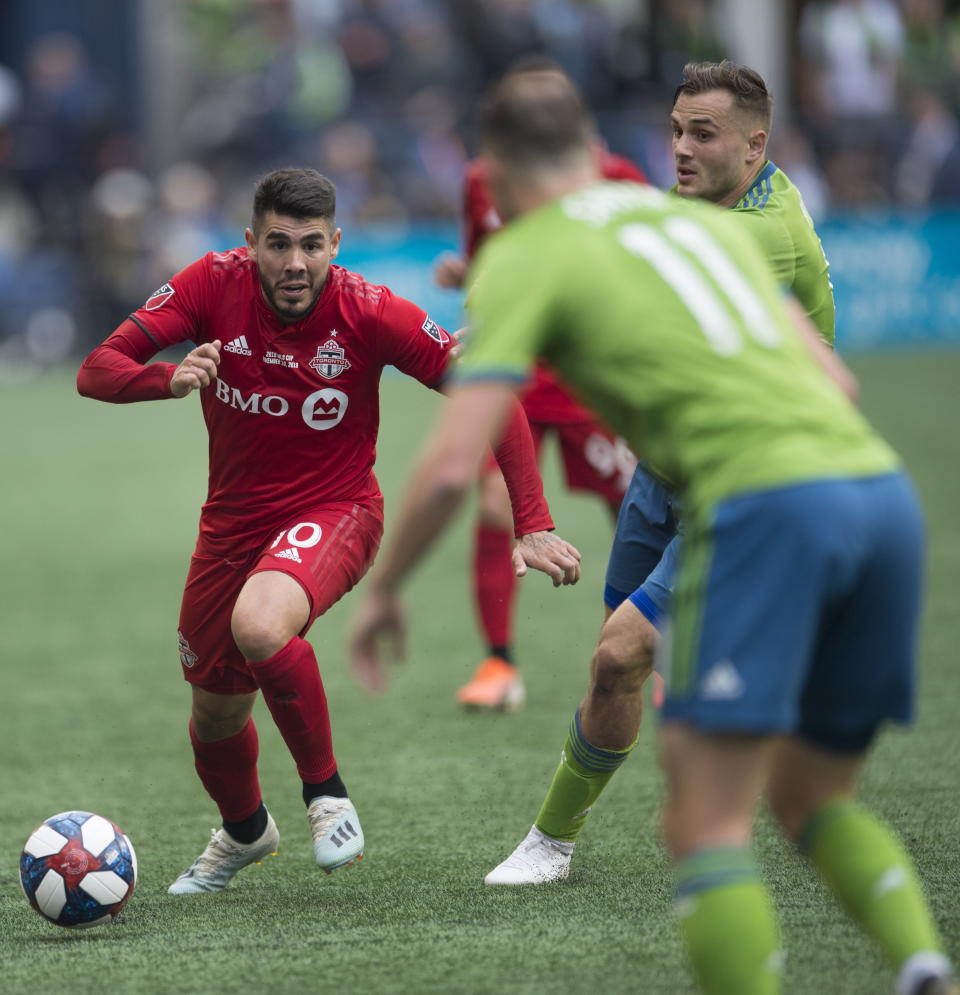 Toronto FC midfielder Alejandro Pozuelo (10) tries to get past Seattle Sounders defender Brad Smith (11) during the first half of the MLS Cup soccer match in Seattle on Sunday, Nov. 10, 2019. (Jonathan Hayward/The Canadian Press via AP)