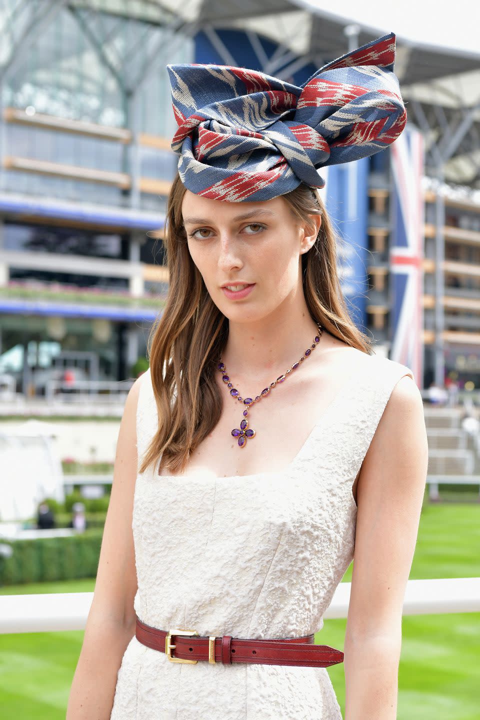 <p>Lady Alice Manners went for a fabulous red, white, and blue knotted fabric headpiece. </p>