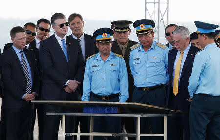 U.S. Secretary of Defense Jim Mattis (2nd R) is guided by Vietnam's Air Force Deputy Commander General Bui Anh Chung (3rd R) while he visits Bien Hoa airbase, where the U.S. army stored the defoliant Agent Orange during the Vietnam War, in Bien Hoa city, outside Ho Chi Minh city, Vietnam October 17, 2018. REUTERS/Kham/Pool