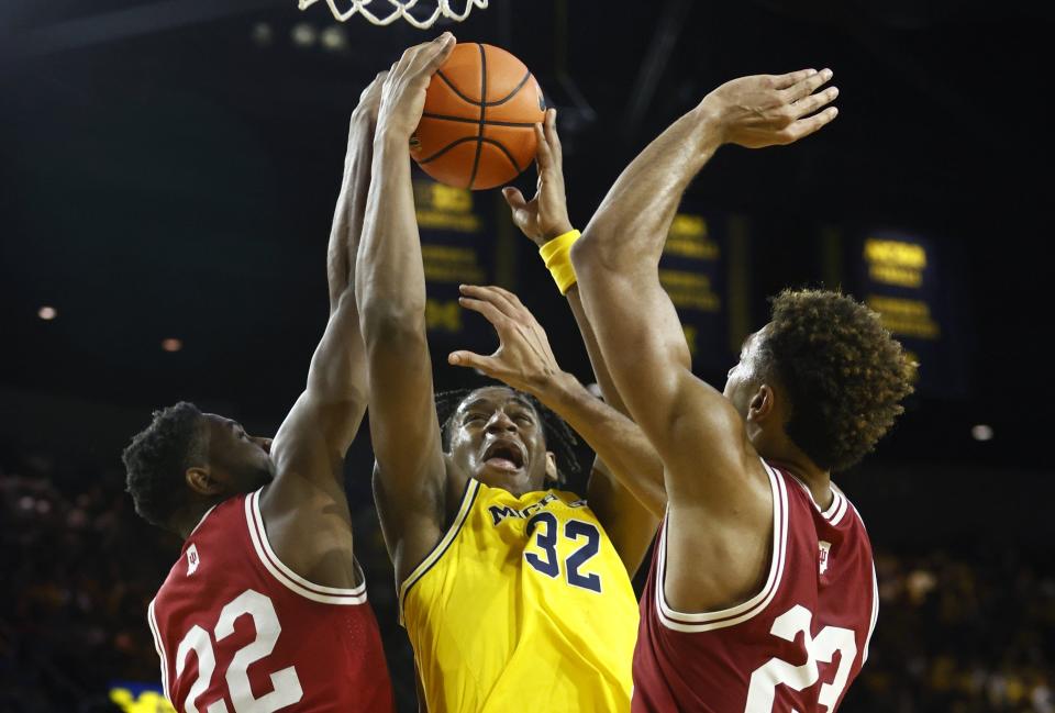 Michigan forward Tarris Reed Jr. has his shot blocked by Indiana forward Jordan Geronimo, left, with Indiana forward Trayce Jackson-Davis helping defend on the play in the second half of U-M's 62-61 loss on Saturday, Feb. 11, 2023, at Crisler Center.