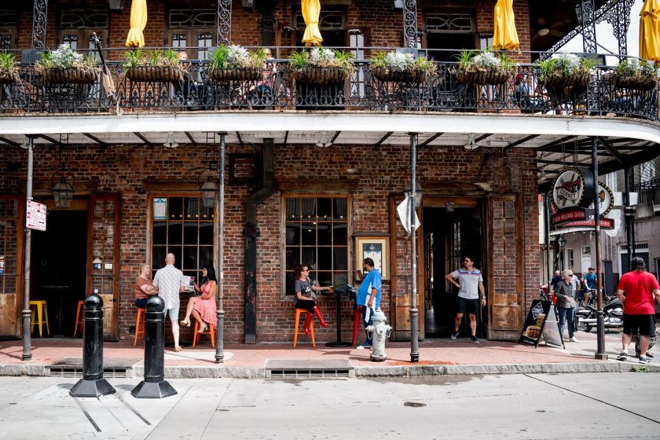 <span class="caption">Guests filled the street seating and balcony at a restaurant on Bourbon Street on May 16, 2020, as New Orleans began lifting some restrictions following two months of closures over the coronavirus.</span> <span class="attribution"><a class="link " href="http://gettyimages.com" rel="nofollow noopener" target="_blank" data-ylk="slk:Claire Bangser/AFP/Getty Images;elm:context_link;itc:0;sec:content-canvas">Claire Bangser/AFP/Getty Images</a></span>