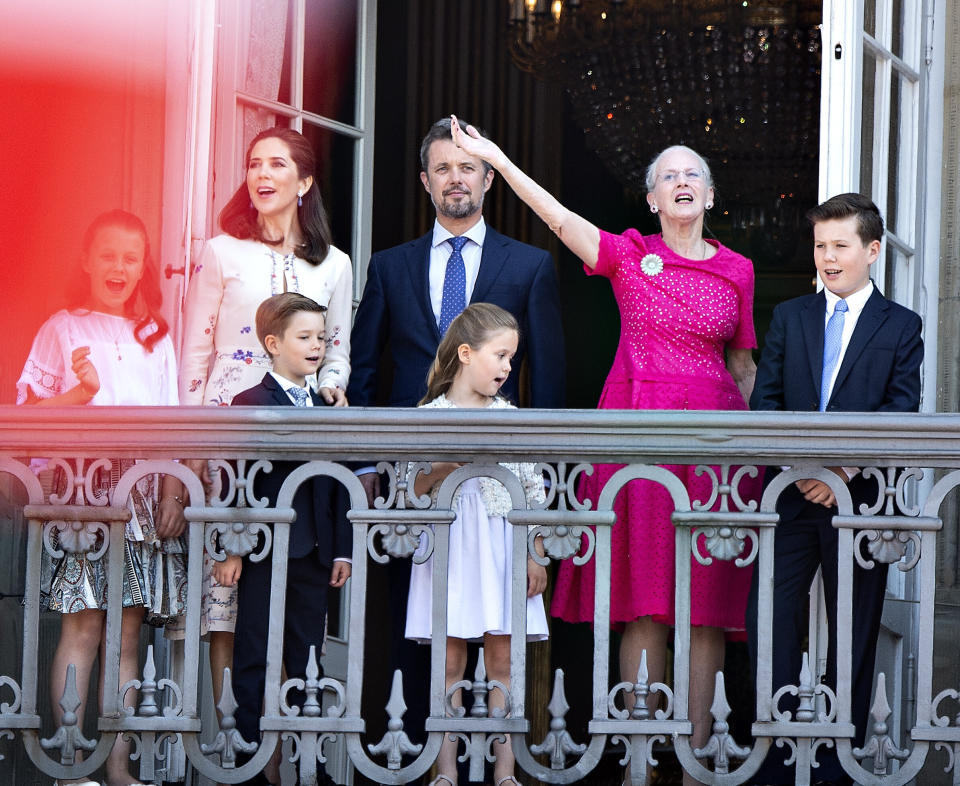 FILE - Queen Margrethe of Denmark, second right, and her son Crown Prince Frederik, center, stand on the balcony at Amalienborg Castle in Copenhagen on May 26, 2018, to celebrate the 50th birthday of the Crown Prince. Denmark’s popular monarch Queen Margrethe is marking 50 years on the throne on Friday Jan. 14, 2022, with low-key events. The public celebrations of Friday's anniversary have been delayed until September due to the pandemic. (Henning Bagger/Ritzau Scanpix via AP, File)