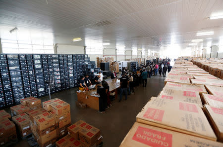 Brazilian electoral workers seal electronic ballot boxes in Brasilia, Brazil September 19, 2018. REUTERS/Adriano Machado