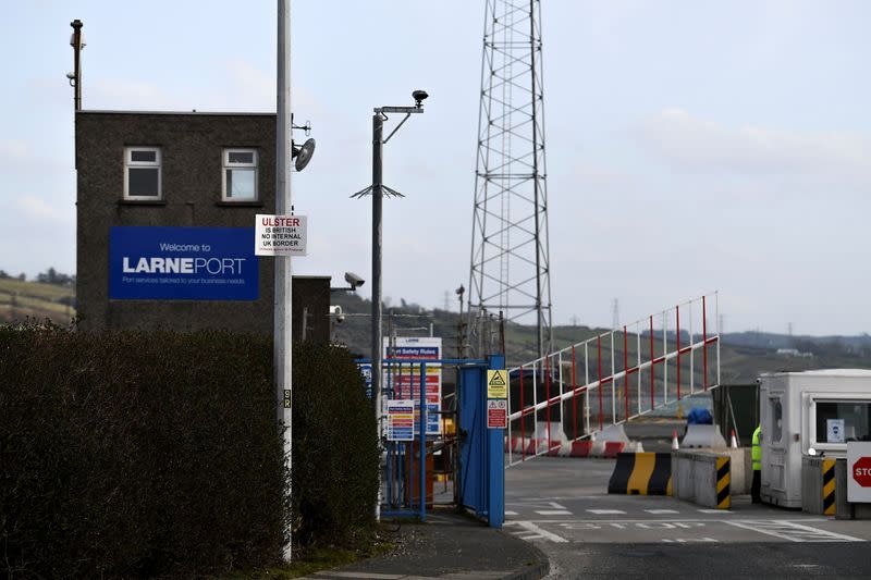 A sign is seen with a message against the Brexit border checks in relation to the Northern Ireland protocol at the harbour in Larne