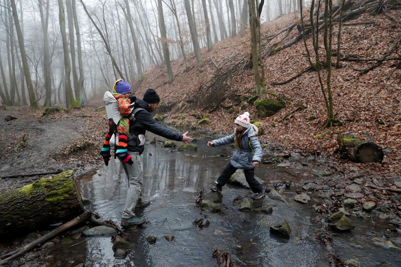 Miklosi helps his daughter Boglarka, 8, as they hike on National Blue Trail along the Pilis Mountains near Pilisszentlaszlo