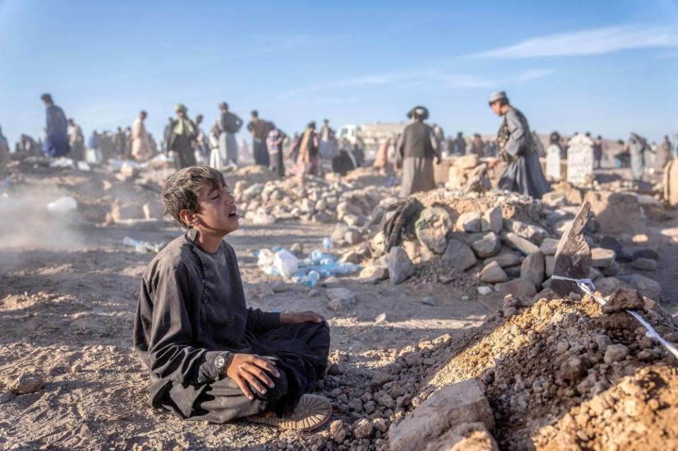 An Afghan boy mourns next to the grave of his little brother who died due to an earthquake, in Zenda Jan district in Herat province, western of Afghanistan, on Oct. 9.<span class="copyright">Ebrahim Noroozi—AP</span>