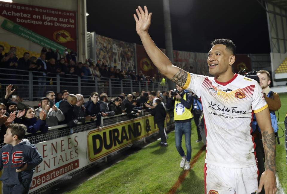 Catalans Dragons Israel Folau waves to the crowd after the Super League rugby match between Catalans Dragons and Castleford Tigers at Stade Gilbert Brutus in Perpignan, France, Saturday, Feb. 15, 2020. (AP Photo/Joan Monfort)