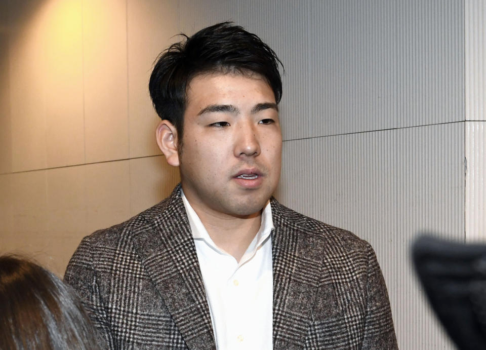 In this Dec. 16, 2018, photo, Japanese baseball player Yusei Kikuchi speaks to journalists before he leaves for the United States, at Narita international airport in Narita, near Tokyo. The Seattle Mariners have signed Kikuchi to a four-year deal on Wednesday, Jan. 2, 2019 after word first surfaced of an agreement late on New Year’s Eve. Kikuchi was one of the few starter options remaining on the market and will be joining a team with a long history of success with Japanese players. (Kyodo News via AP)