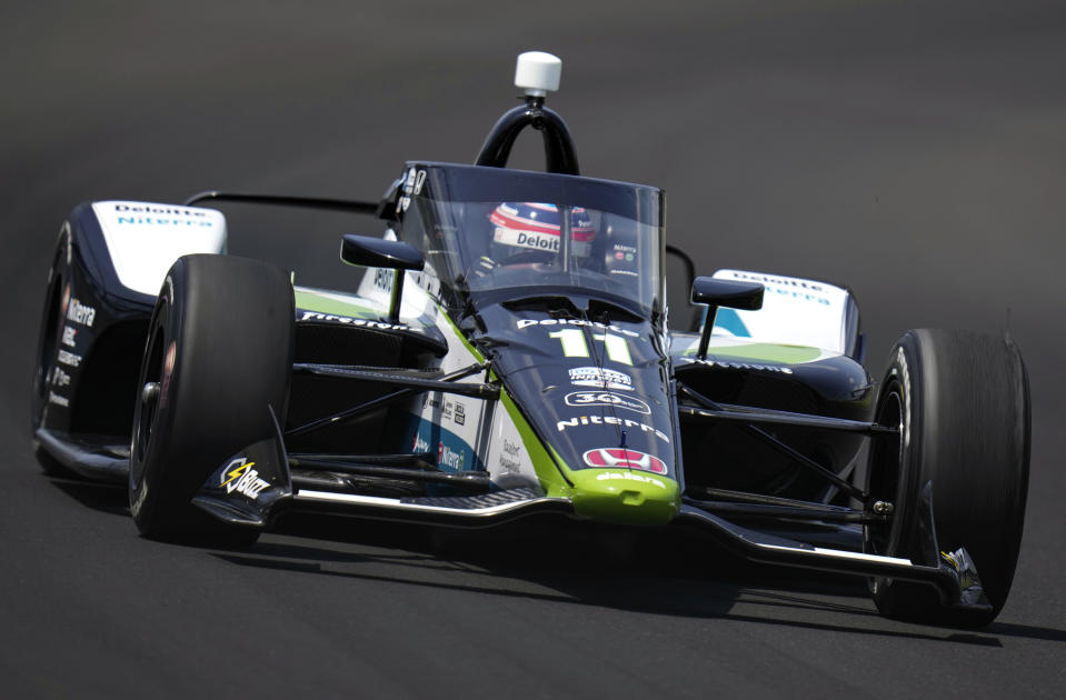 FILE - Takuma Sato, of Japan, drives through the first turn during qualifications for the Indianapolis 500 auto race at Indianapolis Motor Speedway in Indianapolis, May 20, 2023. Two-time Indy 500 winner Sato will re-join Rahal Letterman Lanigan Racing and go for a third title this year. If all goes as planned, he would drive the Honda-powered No. 75 car on May 26, 2024. (AP Photo/Michael Conroy, File)