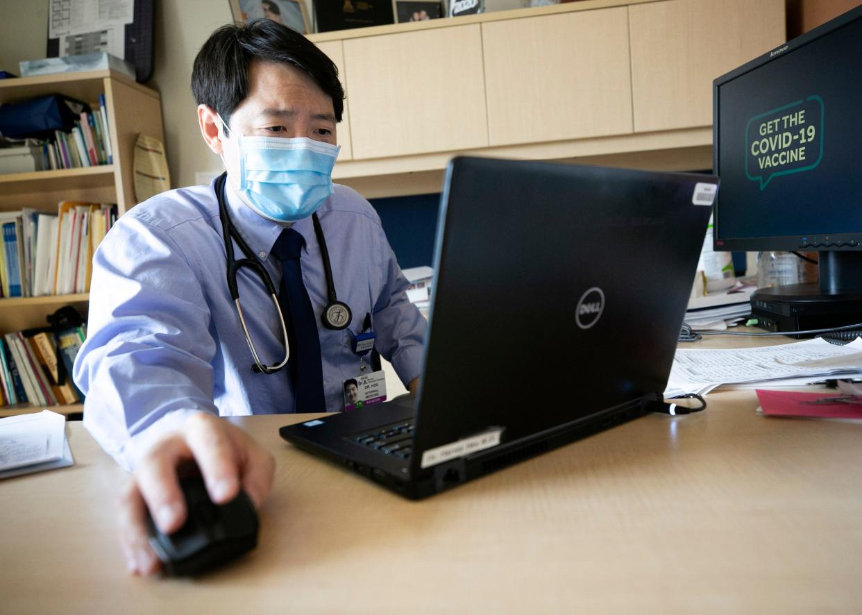 Harvey Hsu, an internal medicine doctor, has a telemedicine appointment with a patient having long-term issues from COVID-19 at his office at the Banner University Medical Center complex in Phoenix on Sept. 10, 2021.