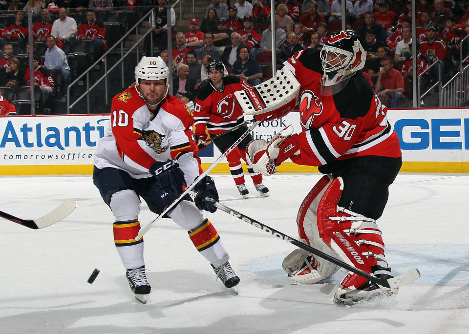 NEWARK, NJ - APRIL 19: Martin Brodeur #30 of the New Jersey Devils shoots the puck clear of former teammate John Madden #10 of the Florida Panthers in Game Four of the Eastern Conference Quarterfinals during the 2012 NHL Stanley Cup Playoffs at Prudential Center on April 19, 2012 in Newark, New Jersey. (Photo by Bruce Bennett/Getty Images)