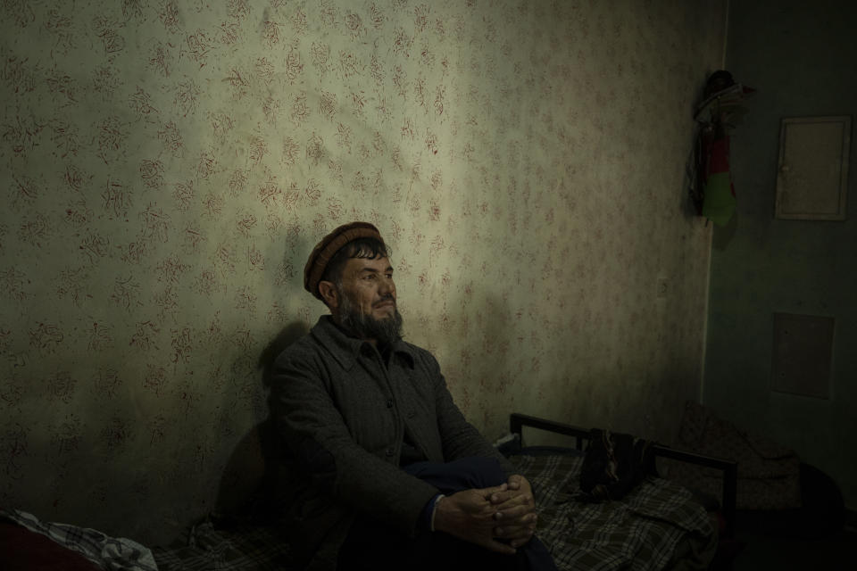 Abdul Fatah sits on his bed inside the Ariana Cinema in Kabul, Afghanistan, Thursday, Nov. 4, 2021. Fatah lives in the cinema where he works as a security guard. (AP Photo/Bram Janssen)