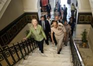 Field Marshal Mohamed Tantawi walks with US Secretary of State Hillary Clinton to a meeting at the Ministry of Defense in Cairo, Egypt. Clinton met Sunday with Egypt's top military leaders, urging them to support a transition to civilian rule as a political struggle triggers fears that rights could be eroded