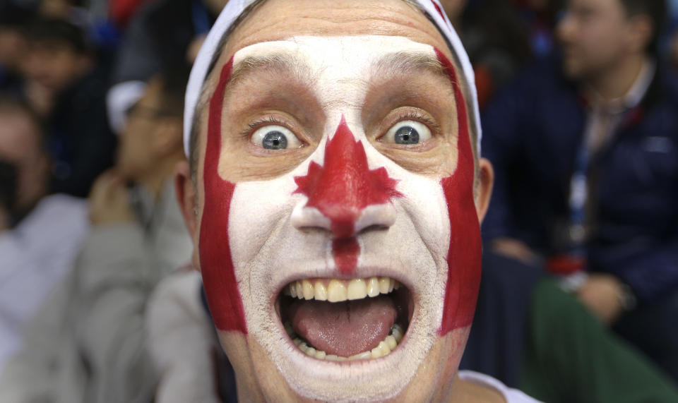 Benoit Lamy from Montreal gives a cheer for his team at the Winter Olympics in Sochi, the Canadian women's hockey team beat the USA 3-2 at Shayba Arena. 