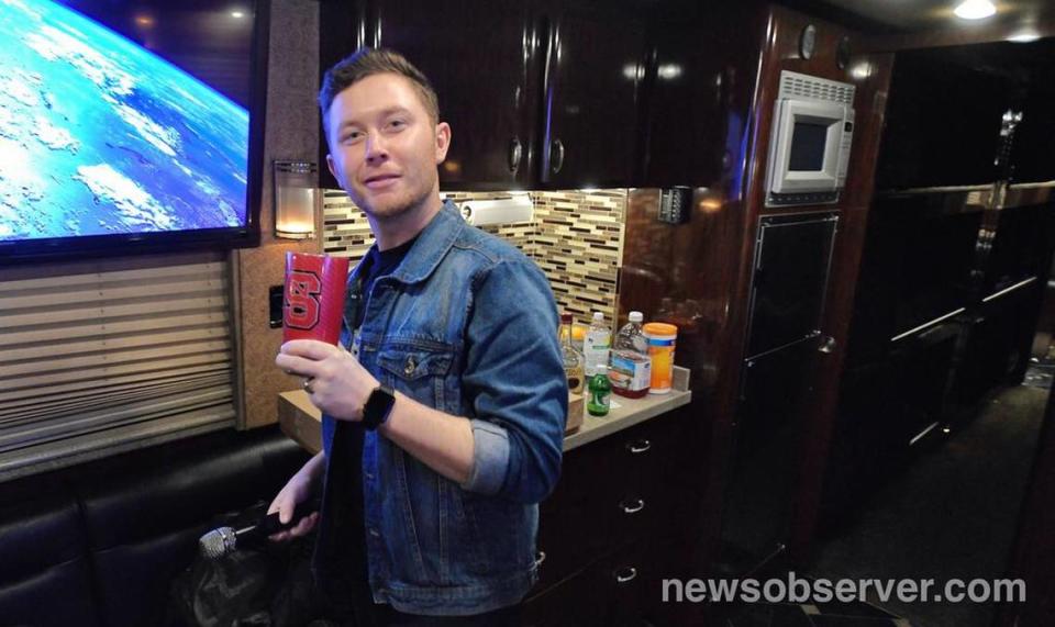 Scotty McCreery flashes his NC State Wolfpack cup as he leaves his tour bus to take the stage for his homecoming show at The Ritz in Raleigh, N.C. Saturday night, Jan. 19, 2019. Scott Sharpe/ssharpe@newsobserver.com