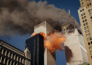 <p>Smoke billows from one of the towers of the World Trade Center as flames and debris explode from the second tower, Tuesday, Sept. 11, 2001. (AP Photo/Chao Soi Cheong)</p> 