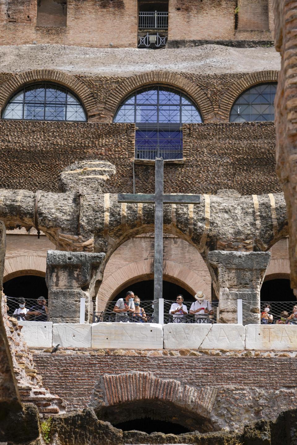 Visitors admire the newly restored lower level of the Colosseum during an event for the media, in Rome, Friday, June 25, 2021. After 2-and-1/2 years of work to shore up the Colosseum’s underground passages, tourists will be able to go down and wander through part of what what had been the ancient arena’s “backstage.” (AP Photo/Andrew Medichini)