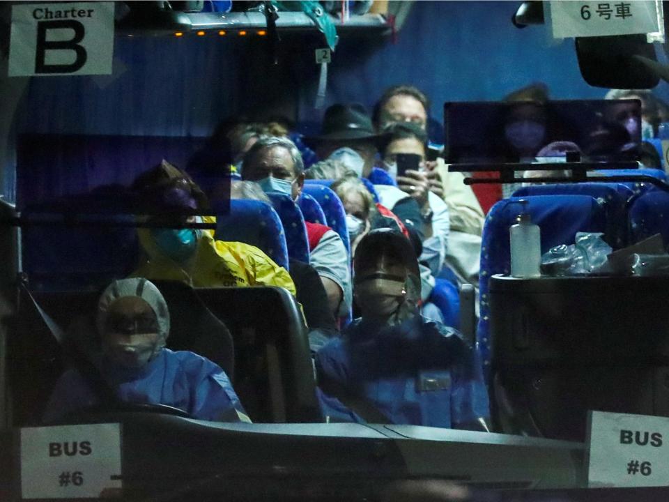 FILE PHOTO: A bus believed to carry the U.S. passengers of the cruise ship Diamond Princess, where dozens of passengers were tested positive for coronavirus, leaves the Daikoku Pier Cruise Terminal in Yokohama, south of Tokyo, Japan, February 17, 2020. REUTERS/Athit Perawongmetha