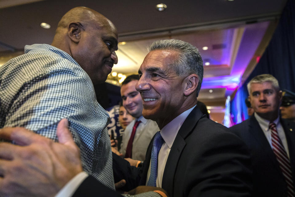 Republican New Jersey gubernatorial candidate Jack Ciattarelli, center, greets a supporter at his election night party in Bridgewater, N.J., early Wednesday, Nov. 3, 2021. (AP Photo/Stefan Jeremiah)