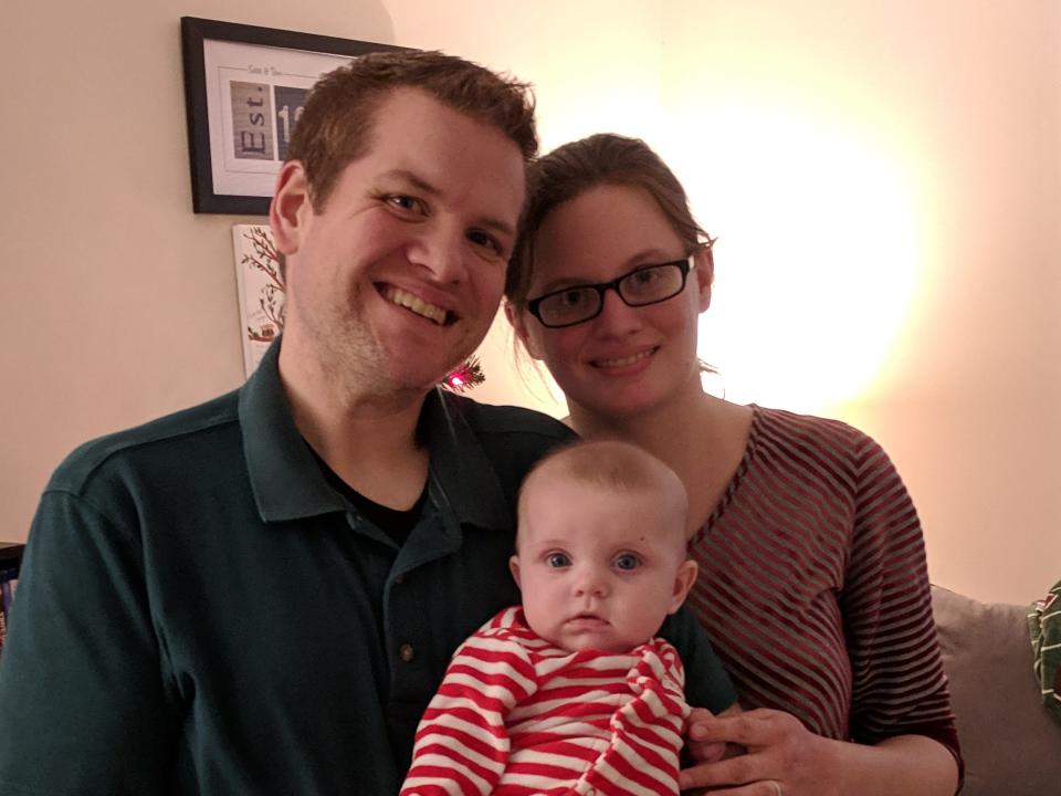 Couple holding baby for a photo