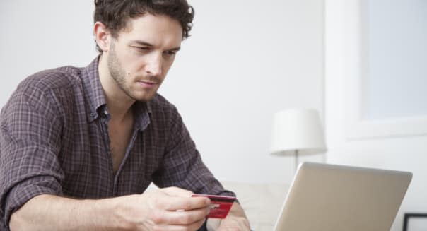 Caucasian man shopping online with credit card