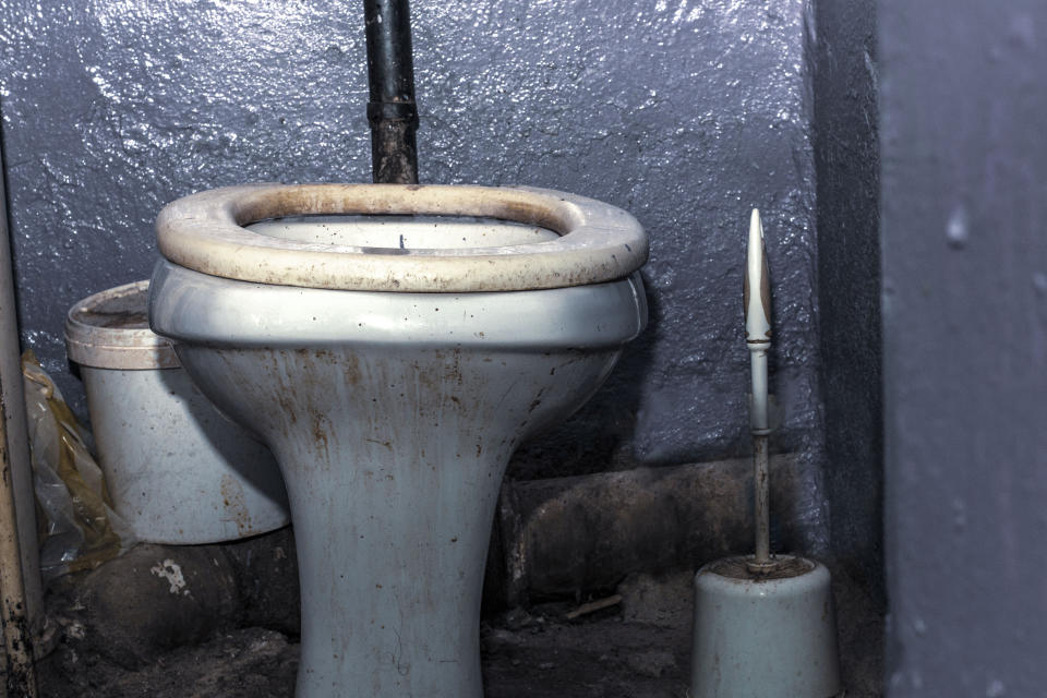 Dirty unhygienic toilet bowl with limescale stain at public restroom