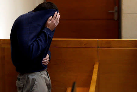 FILE PHOTO: An U.S.-Israeli teen who was arrested in Israel on suspicion of making bomb threats against Jewish community centres in the United States, Australia and New Zealand over the past three month, is seen before the start of a remand hearing at Magistrate's Court in Rishon Lezion, Israel March 23, 2017. REUTERS/Baz Ratner/File Photo