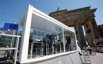 Christian Stroebele, member of the lower house of parliament Bundestag and of the Green Party, (2nd L) reads a copy of the leaked TTIP negotiations inside a public reading room by the environmental campaign group Greenpeace in front of the Brandenburg Gate in Berlin, Germany, May 2, 2016. REUTERS/Fabrizio Bensch