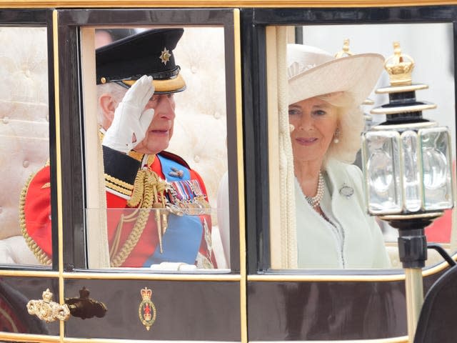 The King and Queen travel along The Mall in a coach to the Trooping the Colour ceremony