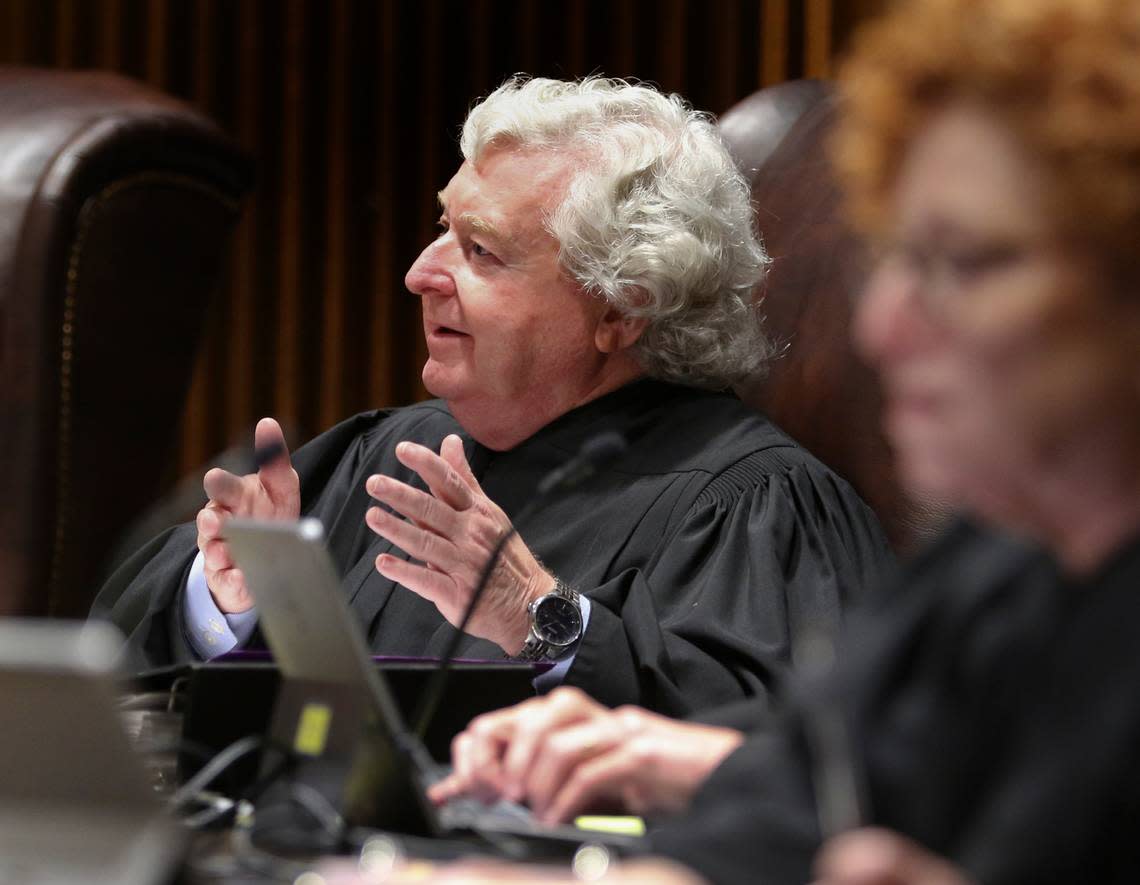 Kansas Supreme Court Justice Dan Biles asks Attorney General Derek Schmidt a question during arguments.