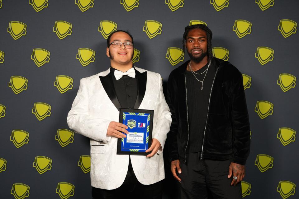 Dallas Cowboys' cornerback Trevon Diggs, right, poses with Crockett's Amado Peña-Gonzalez, the winner of the Tatyanna Bailey Courage Award at the Statesman's High School Sports Awards Show at the Long Center on Wednesday.