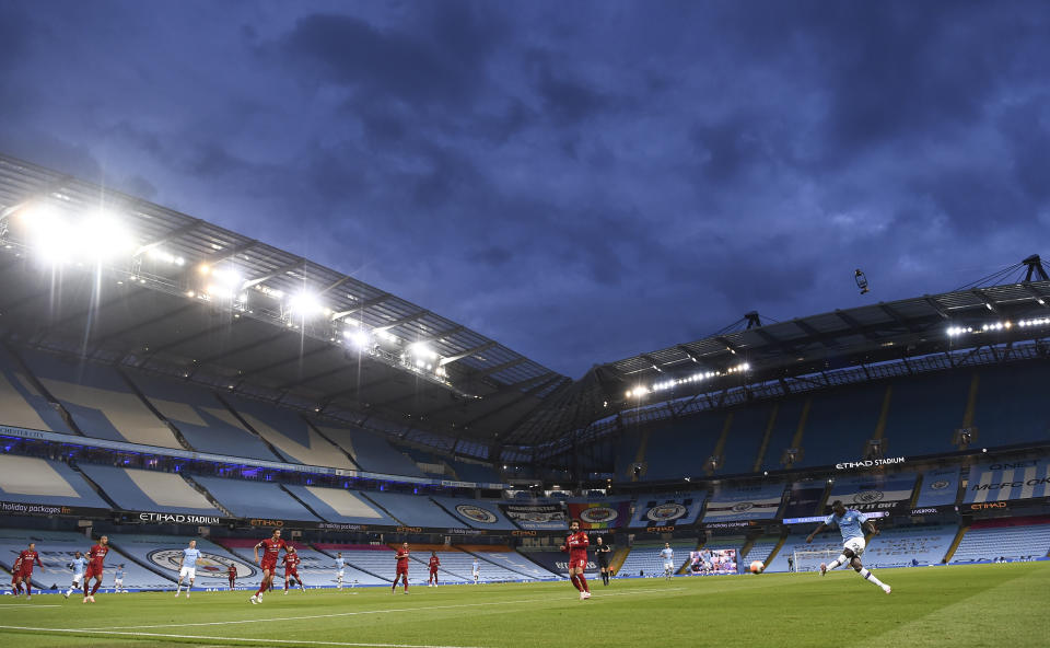 Manchester City's Benjamin Mendy kicks the ball during the English Premier League soccer match between Manchester City and Liverpool at Etihad Stadium in Manchester, England, Thursday, July 2, 2020. (AP Photo/Peter Powell,Pool)