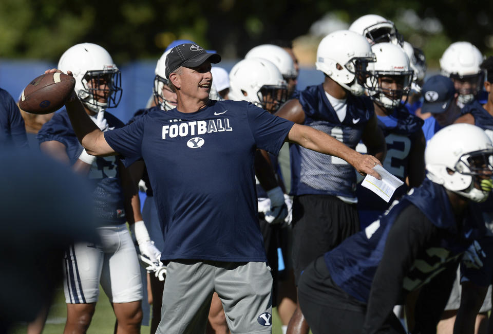 BYU football offensive coordinator and quarterbacks coach Ty Detmer works with the team during NCAA college football practice Thursday, July 27, 2017, in Provo, Utah. (Francisco Kjolseth/The Salt Lake Tribune via AP)