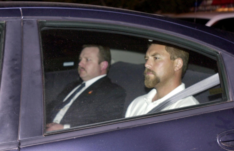 FILE - Scott Peterson, right, arrives at a county jail in Modesto, Calif., coming from San Diego on April 19, 2003, after he was arrested in connection with the death of his wife, Laci Peterson, who was eight months pregnant when she vanished on Christmas Eve. A California judge on Tuesday, Dec. 20, 2022, rejected a new murder trial for Peterson, nearly 20 years after he was charged with dumping the bodies of his pregnant wife and the unborn child they planned to name Conner into the San Francisco Bay on Christmas Eve 2002. (AP Photo/Paul Sakuma, File)