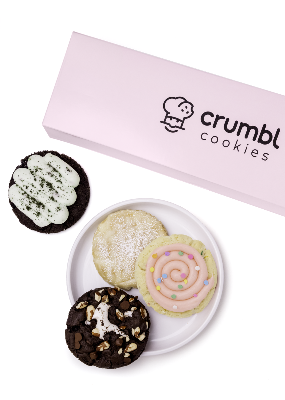 A variety of Crumbl Cookies sold in the iconic pink box.