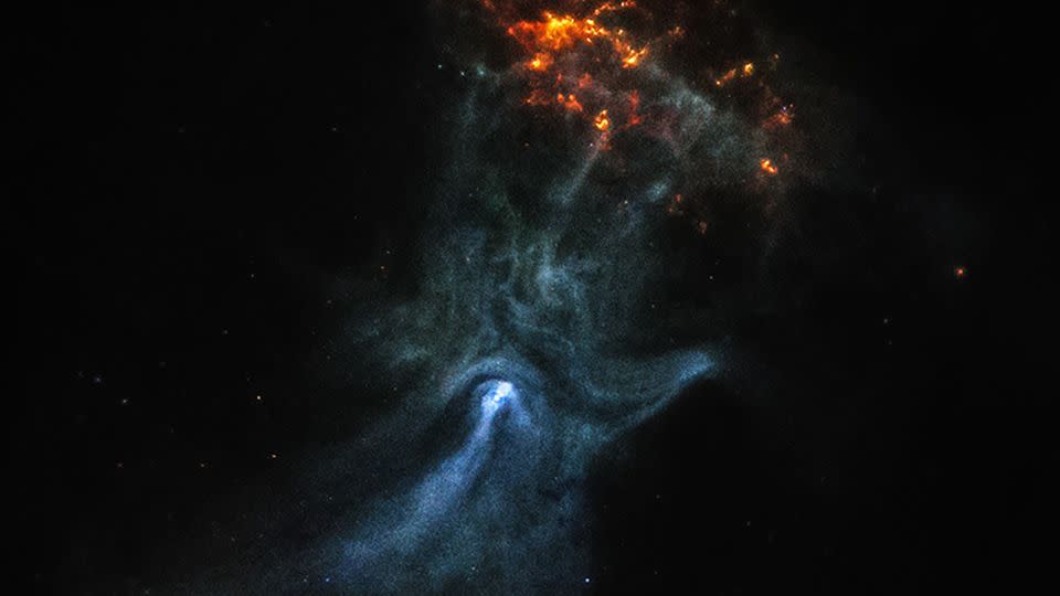 Chandra's original image of the nebula shows captured the pulsar, the bright white spot within the "palm," while the orange cloud are the remnants of a supernova explosion. - NASA/MSFC