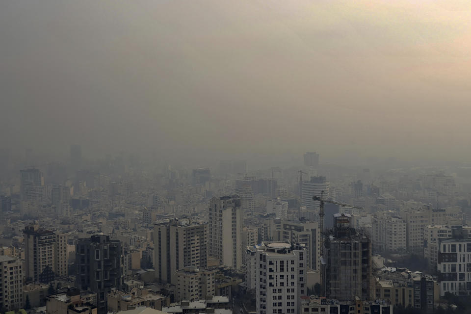 Air pollution blankets the skyline in Tehran, Iran, Wednesday, Dec 23, 2020. Iran's capital and its major cities have been plunged into darkness as rolling outages in recent weeks left millions with no electricity for hours. With toxic smog blanketing the skies in Tehran and the country buckling under the strain of the pandemic and sanctions targeting Iran’s oil and gas industry, speculation about the spate of blackouts gripped social media. Soon, fingers pointed at an unlikely culprit: Bitcoin. (AP Photo/Ebrahim Noroozi)