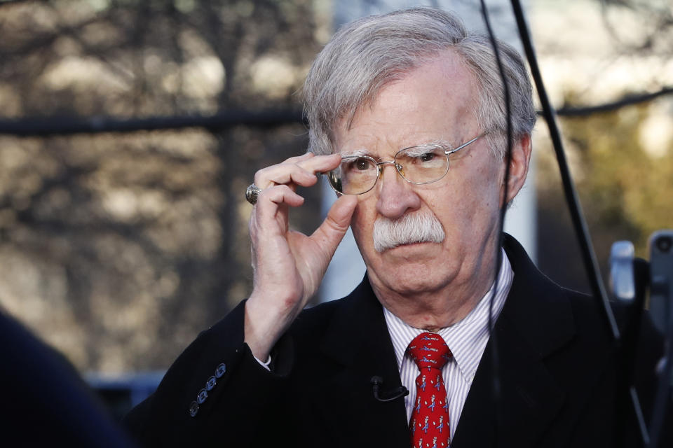 FILE - In this March 5, 2019 file photo, national security adviser John Bolton adjusts his glasses before an interview at the White House in Washington. (AP Photo/Jacquelyn Martin)