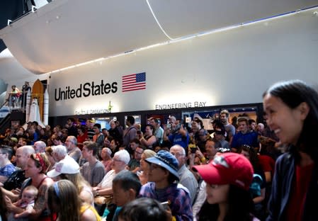 Visitors watch footage at the exact 50 year anniversary of the Apollo 11 moon landing at the Museum of Flight in Seattle