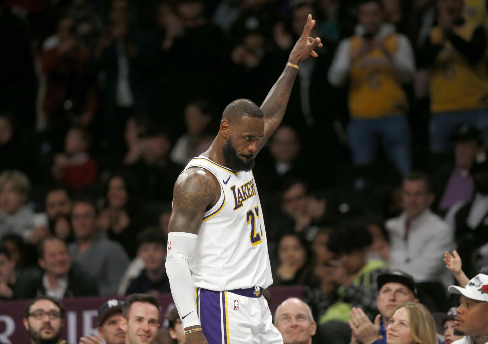 Los Angeles Lakers forward LeBron James acknowledges cheers from the crowd as he heads to the bench late in the fourth quarter of the team's NBA basketball game against the Brooklyn Nets on Sunday, March 31, 2024, in New York. (AP Photo/John Munson)