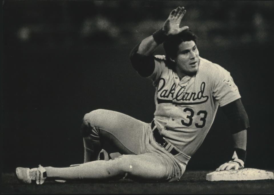 Jose Canseco asks for time after stealing his 40th base of the 1988 season, making him the first player in Major League history to hit 40 home runs and steal 40 bases in one year.