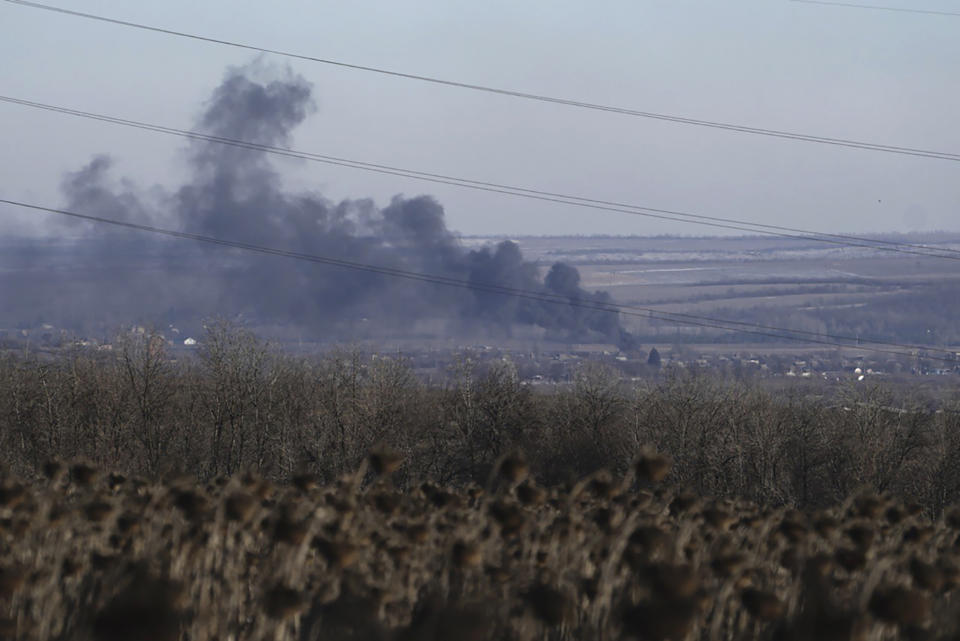 FILE - Smoke billows during fighting between Ukrainian and Russian forces in Soledar, Donetsk region, Ukraine, Wednesday, Jan. 11, 2023. Soledar and Bakhmut again highlighted a bitter rift between the top military brass and Yevgeny Prigozhin, a rogue millionaire whose Wagner Group military contractor has played an increasing role in Ukraine. (AP Photo/Libkos, File)