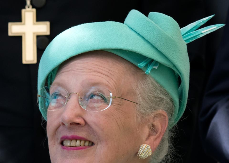 Denmark's Queen Margrethe II looks up before she plants a tree in the Luther Garden in Wittenberg, Germany, Oct. 2, 2016.