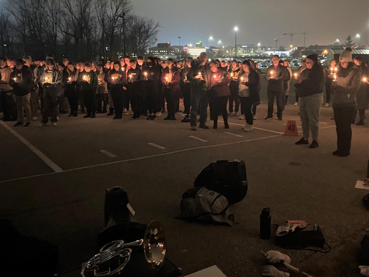 Members of the University of Missouri community gather at a vigil for the late Alex Jackson on Dec. 7, 2022, at the Marching Mizzou practice fields in Columbia, Mo. Jackson, a beloved member of Marching Mizzou, passed away from cancer on Thanksgiving Day.