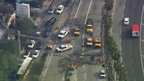 This video still image provided by KABC-TV shows workers clearing debris across the entrance to Los Angles International Airport left by protesters on Wednesday, Dec. 27, 2023, near Los Angeles International Airport. Pro-Palestinian protesters briefly blocked entrance roads to airports in New York and Los Angeles on Wednesday, forcing some travelers to set off on foot to bypass the jammed roadway. (KABC-TV via AP)