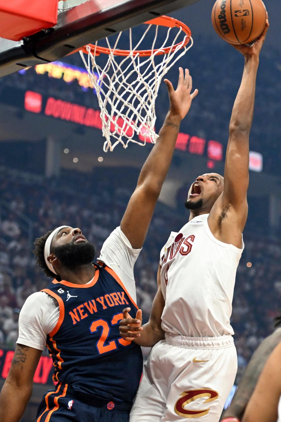 Cleveland Cavaliers' Evan Mobley shoots against New York Knicks' Mitchell Robinson (23) during the first half of Game 1 in a first-round NBA basketball playoffs series Saturday, April 15, 2023, in Cleveland.